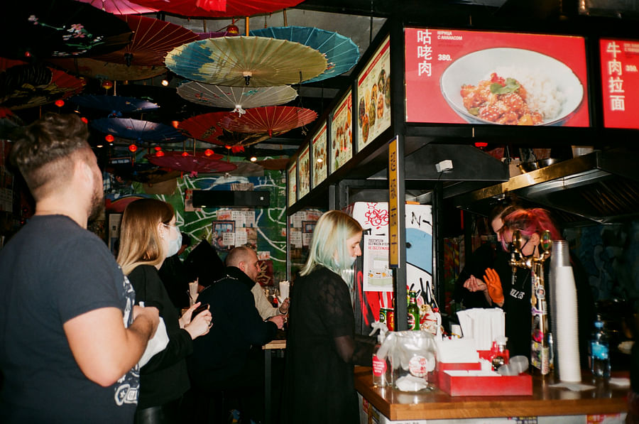 A diner asking a server about a menu item