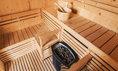 What is the proper attire for a public sauna?